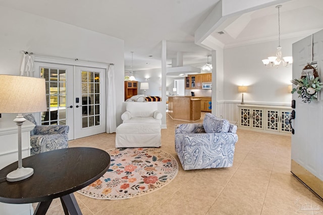 5140 Grumann Dr, Pensacola, FL 32507 - living area with french doors, light tile patterned floors, wainscoting, a ceiling fan, and a chandelier