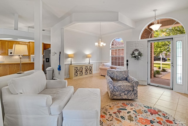 5140 Grumann Dr, Pensacola, FL 32507 - living room featuring light tile patterned floors, a chandelier, and a wainscoted wall