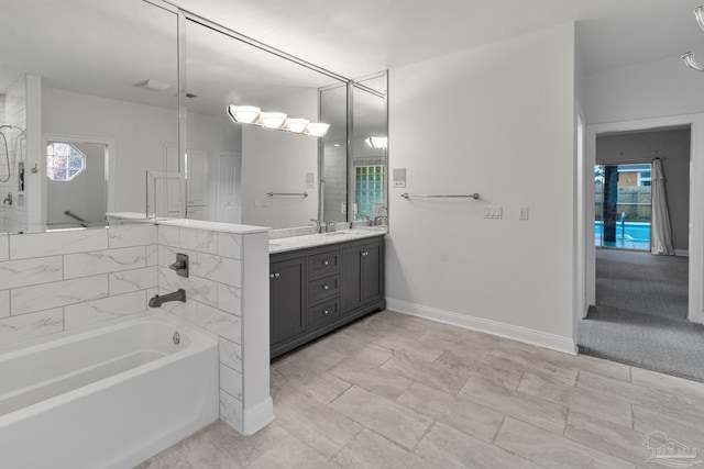 5140 Grumann Dr, Pensacola, FL 32507 - bathroom featuring a tub, vanity, and baseboards