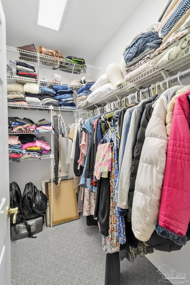 5140 Grumann Dr, Pensacola, FL 32507 - walk in closet featuring carpet floors, a skylight, and lofted ceiling