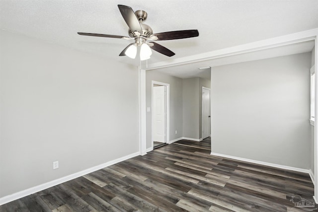 unfurnished room with dark hardwood / wood-style flooring, a textured ceiling, and ceiling fan