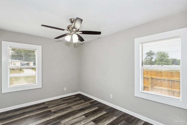 spare room featuring dark wood-type flooring and ceiling fan