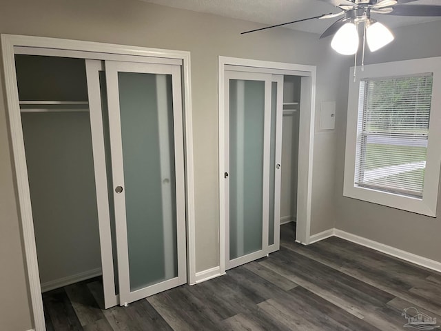 unfurnished bedroom with dark hardwood / wood-style flooring and ceiling fan