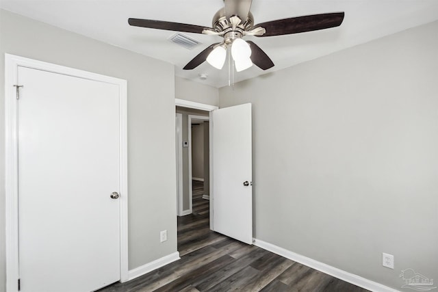 unfurnished bedroom featuring dark hardwood / wood-style floors and ceiling fan