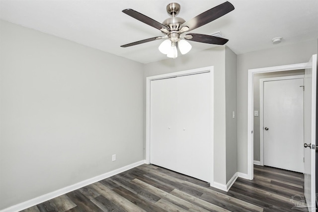 unfurnished bedroom featuring dark hardwood / wood-style flooring, a closet, and ceiling fan