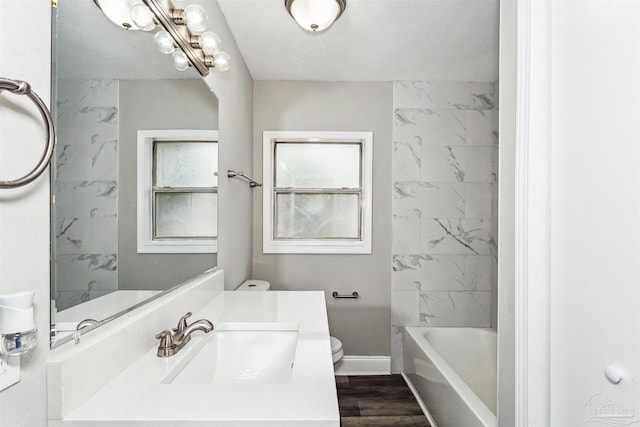 full bathroom featuring vanity, hardwood / wood-style floors, toilet, and shower / bath combination