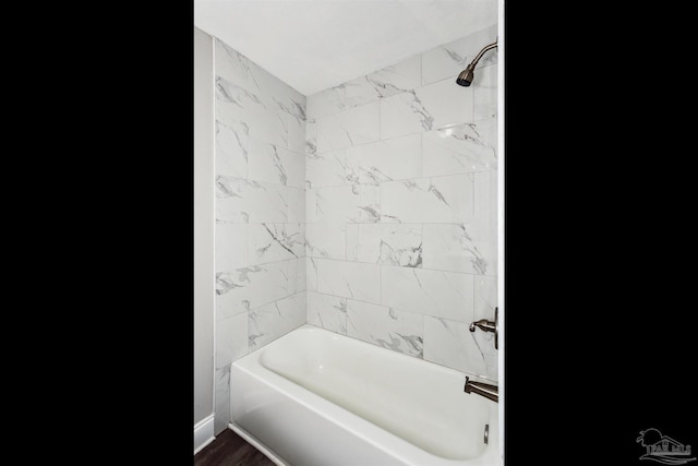 bathroom featuring shower / washtub combination and hardwood / wood-style floors