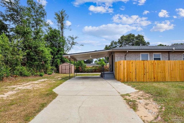 view of front facade with a carport and a shed