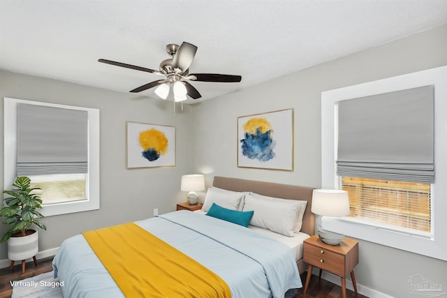 bedroom with ceiling fan and dark hardwood / wood-style flooring