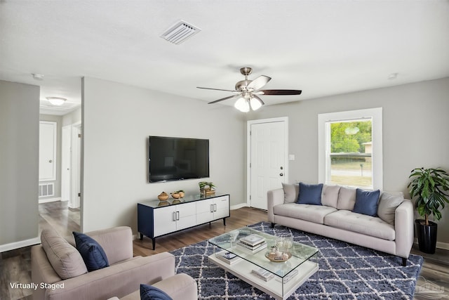 living room with dark hardwood / wood-style flooring and ceiling fan