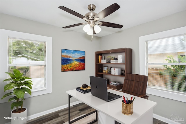 office with dark wood-type flooring and ceiling fan