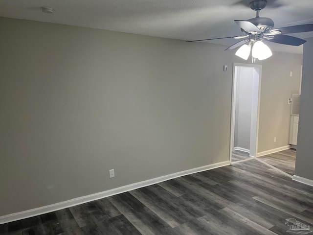 unfurnished room with dark hardwood / wood-style floors and ceiling fan