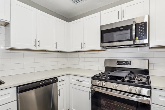 kitchen featuring white cabinetry, tasteful backsplash, and stainless steel appliances