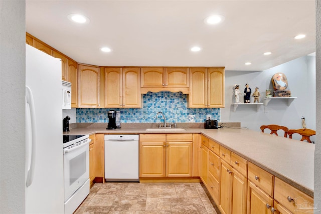 kitchen featuring white appliances, backsplash, and sink