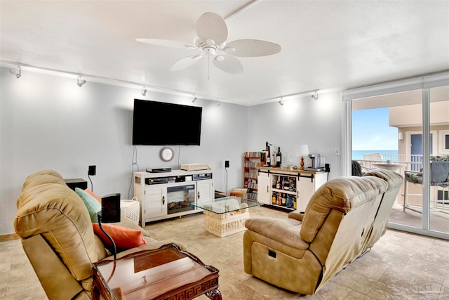 living room with ceiling fan and track lighting