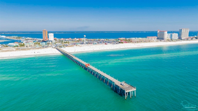 birds eye view of property with a water view and a beach view