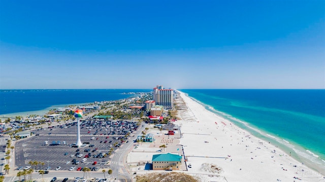 bird's eye view featuring a view of the beach and a water view