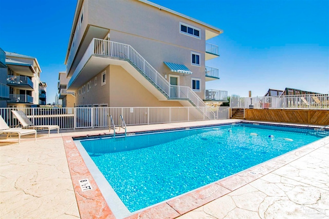 view of swimming pool featuring a patio area