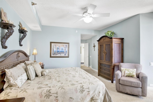 bedroom featuring ceiling fan, light carpet, and a textured ceiling