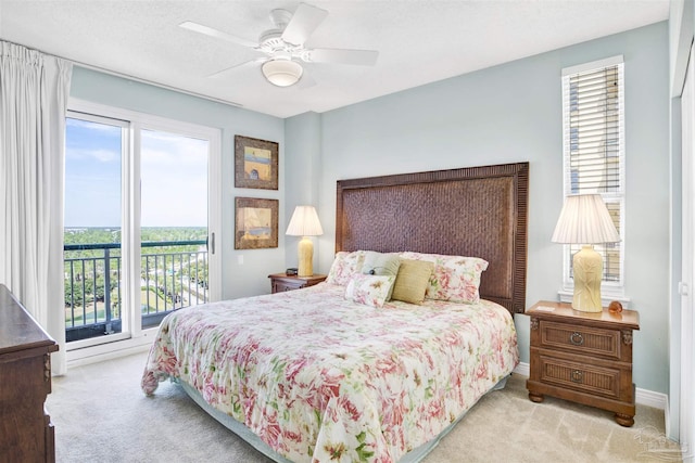 carpeted bedroom with ceiling fan and access to outside