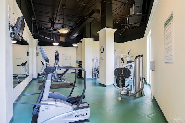 workout area with a high ceiling