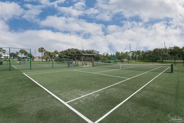 view of tennis court featuring a pergola