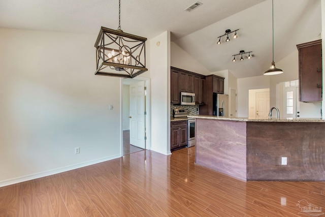 3086 Myrshine Dr, Pensacola, FL 32506 - kitchen featuring stainless steel appliances, dark brown cabinets, vaulted ceiling, visible vents, and decorative backsplash