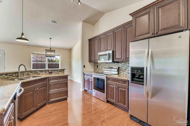 3086 Myrshine Dr, Pensacola, FL 32506 - kitchen featuring stainless steel appliances, vaulted ceiling, visible vents, a sink, and tasteful backsplash