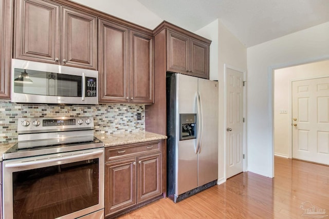 3086 Myrshine Dr, Pensacola, FL 32506 - kitchen with light wood-type flooring, decorative backsplash, light stone counters, and appliances with stainless steel finishes