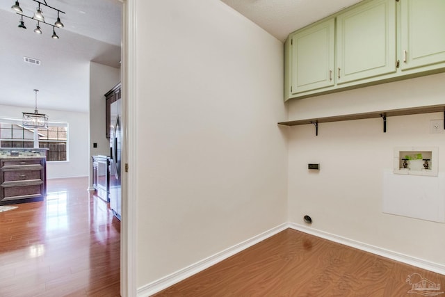 3086 Myrshine Dr, Pensacola, FL 32506 - washroom with wood finished floors, an inviting chandelier, cabinet space, visible vents, and washer hookup