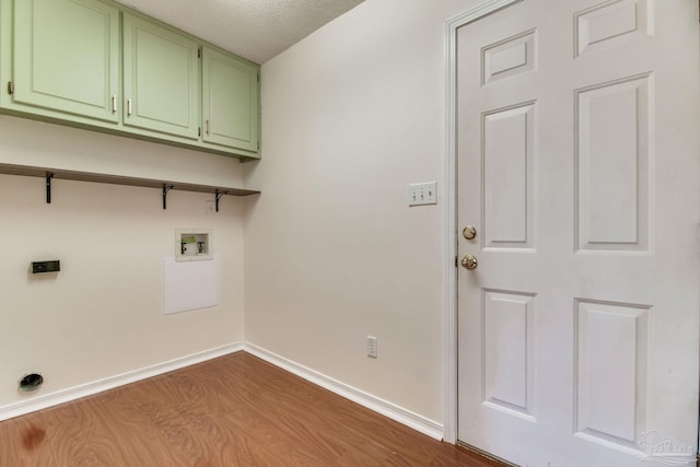 3086 Myrshine Dr, Pensacola, FL 32506 - washroom featuring a textured ceiling, baseboards, hookup for a washing machine, wood finished floors, and cabinet space