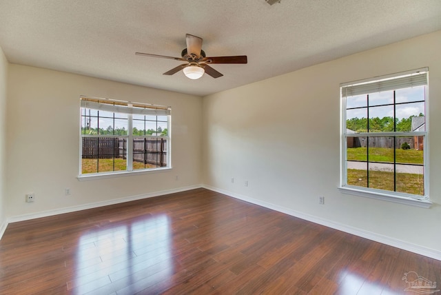 3086 Myrshine Dr, Pensacola, FL 32506 - unfurnished room with dark wood finished floors, a wealth of natural light, a ceiling fan, and baseboards