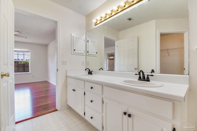 3086 Myrshine Dr, Pensacola, FL 32506 - full bathroom with double vanity, visible vents, tile patterned floors, and a sink