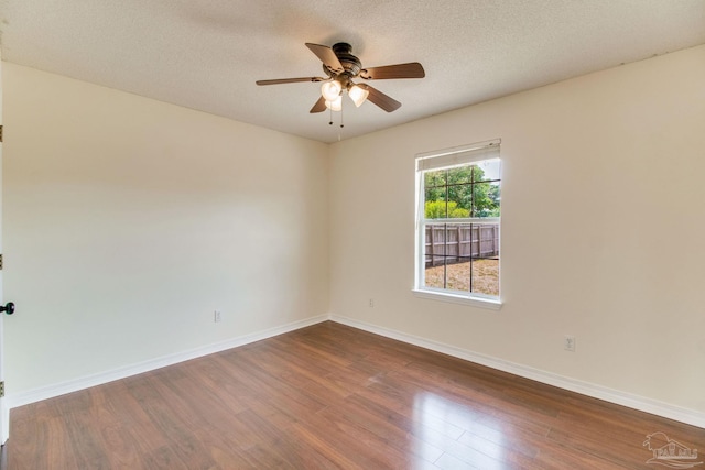 3086 Myrshine Dr, Pensacola, FL 32506 - spare room featuring baseboards, a ceiling fan, dark wood-style floors, and a textured ceiling