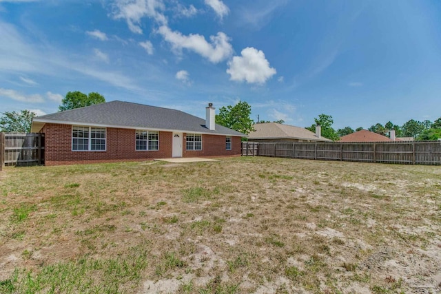 3086 Myrshine Dr, Pensacola, FL 32506 - back of house with a patio area, a chimney, a lawn, a fenced backyard, and brick siding