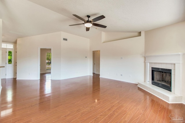 3086 Myrshine Dr, Pensacola, FL 32506 - unfurnished living room featuring vaulted ceiling, light wood-style floors, ceiling fan, a fireplace, and visible vents