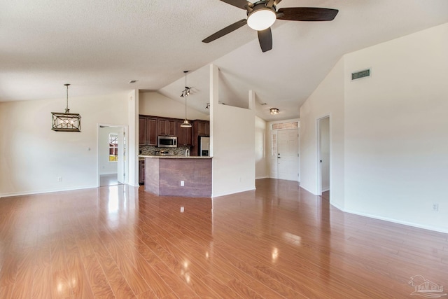 3086 Myrshine Dr, Pensacola, FL 32506 - unfurnished living room with baseboards, visible vents, light wood-style floors, ceiling fan, and high vaulted ceiling
