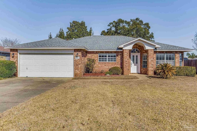 ranch-style home featuring a garage and a front yard