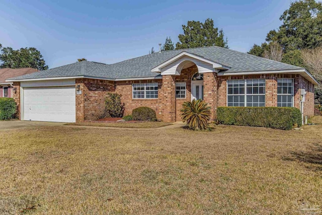 ranch-style home featuring a garage and a front lawn