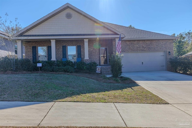 ranch-style home featuring a garage, a porch, and a front lawn