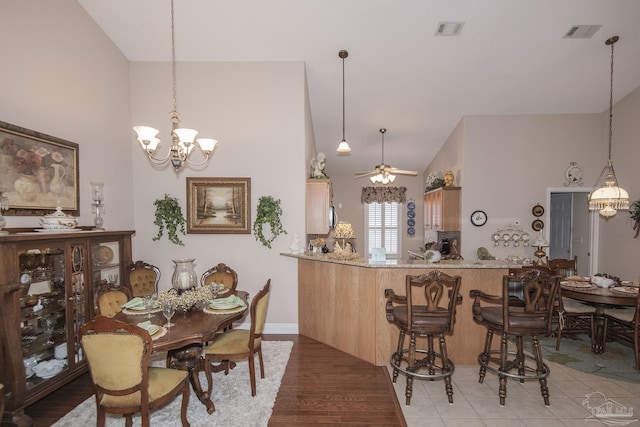1013 Patriot Pl, Pensacola, FL 32534 - dining room featuring wood-type flooring, ceiling fan with notable chandelier, and high vaulted ceiling