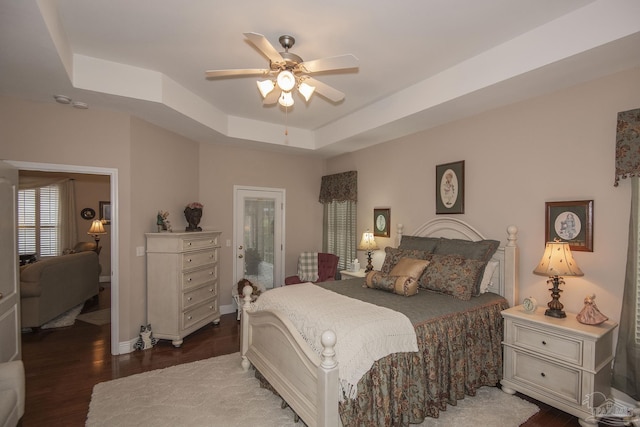 1013 Patriot Pl, Pensacola, FL 32534 - bedroom featuring a tray ceiling, dark wood-type flooring, and ceiling fan