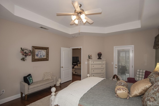 1013 Patriot Pl, Pensacola, FL 32534 - bedroom featuring dark wood-type flooring, ceiling fan, and a tray ceiling