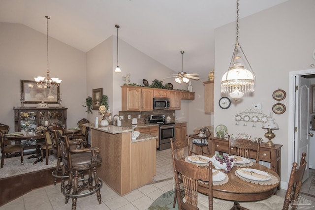 1013 Patriot Pl, Pensacola, FL 32534 - kitchen featuring light stone counters, high vaulted ceiling, kitchen peninsula, stainless steel appliances, and backsplash
