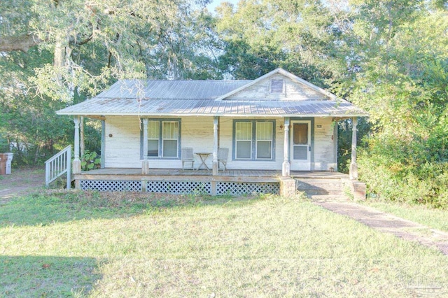 view of front of home with a front yard and a porch