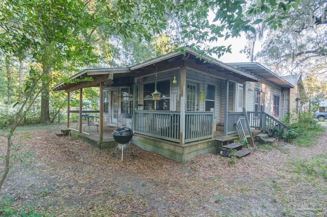 view of side of home with a porch