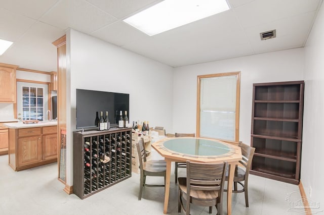 dining room with a drop ceiling and sink