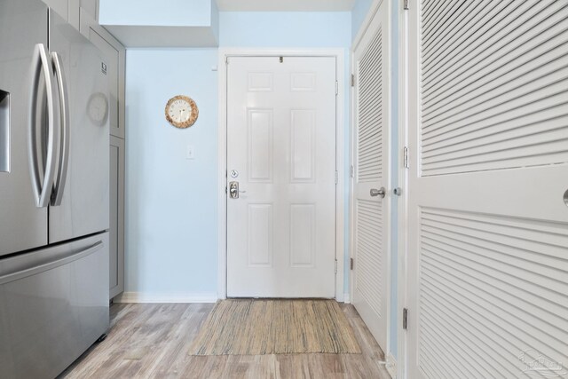 interior space featuring light hardwood / wood-style floors and stainless steel refrigerator