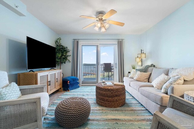 living room featuring ceiling fan and wood-type flooring