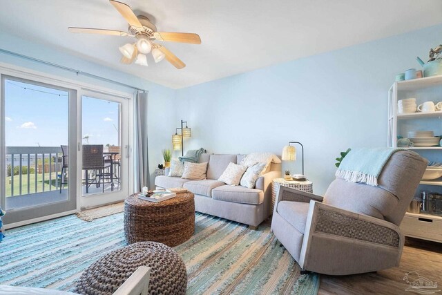 living room featuring ceiling fan and hardwood / wood-style floors